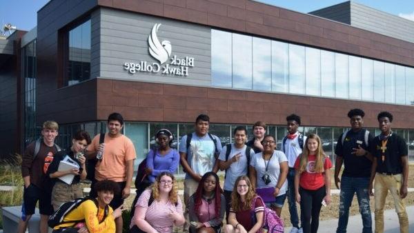 students pose in front of the Building 1 addition